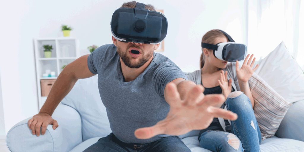Couple On The Couch In VR Helmets